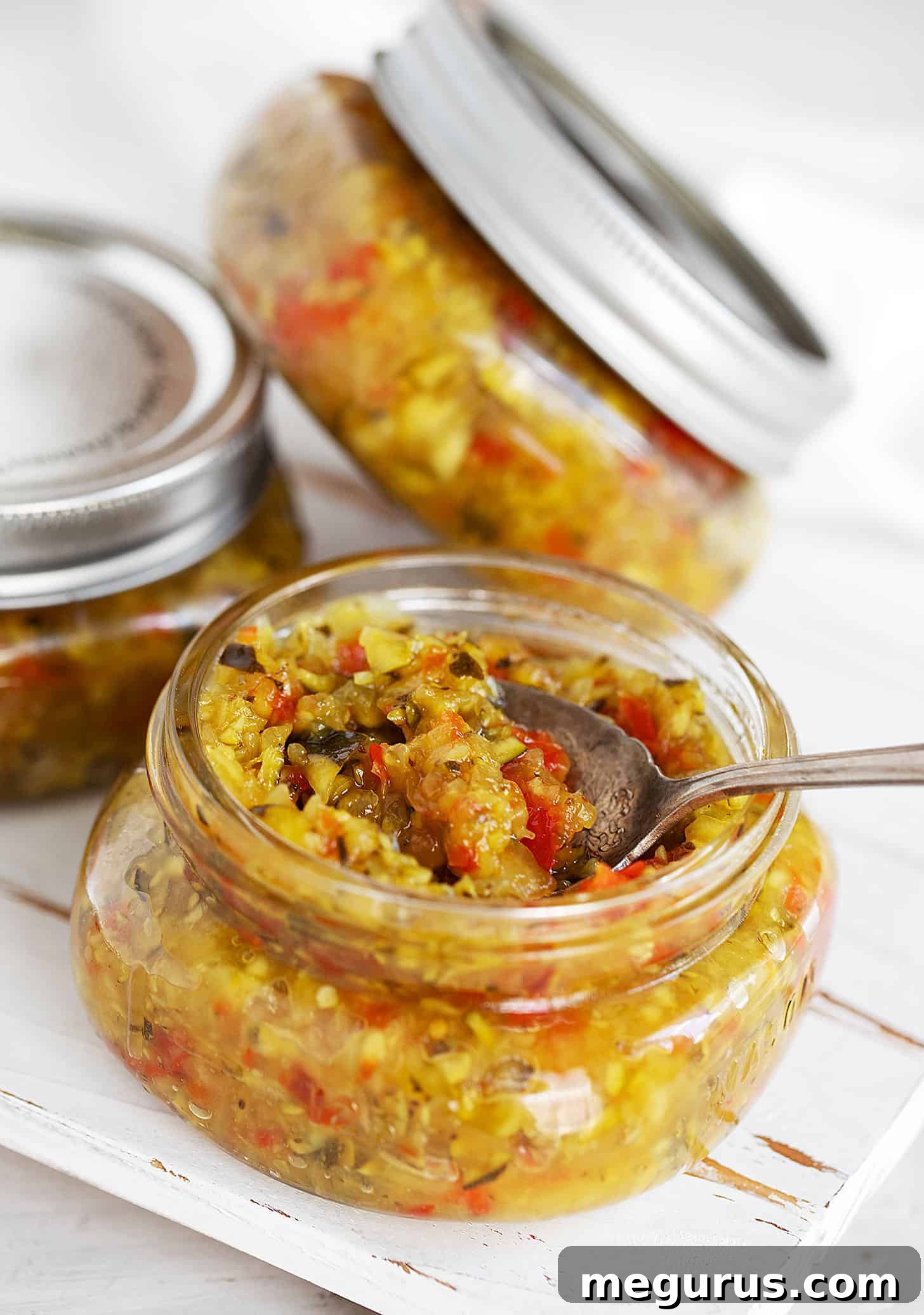 A collection of sealed jars of homemade zucchini relish.