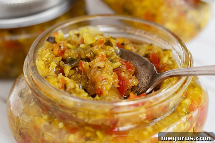 Zucchini mustard relish in jars with spoon