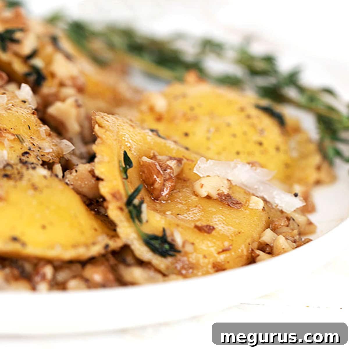 brown butter and walnut ravioli in white bowl