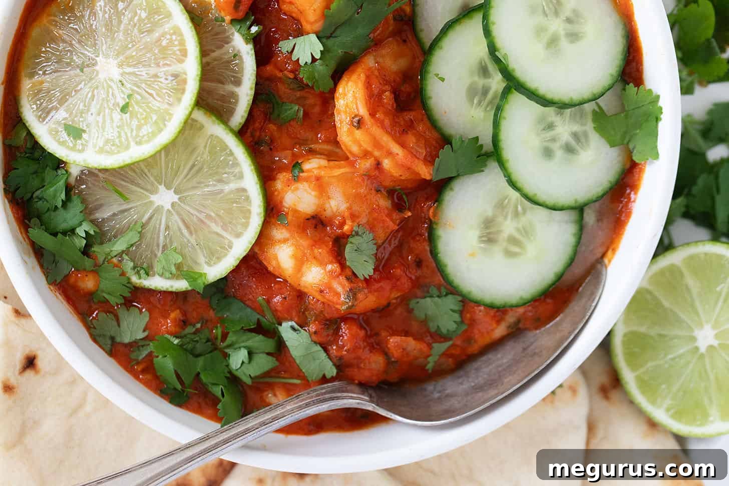 A bowl of creamy, rich Indian Butter Shrimp garnished with fresh cilantro, ready to be served.