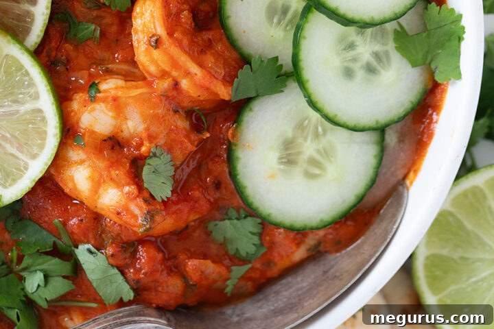 A close-up shot of Indian Butter Shrimp in a white bowl, ready to be enjoyed.