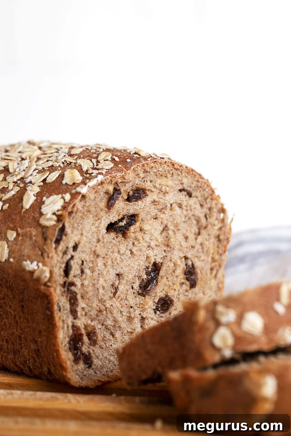 cinnamon raisin oatmeal bread on cutting board sliced