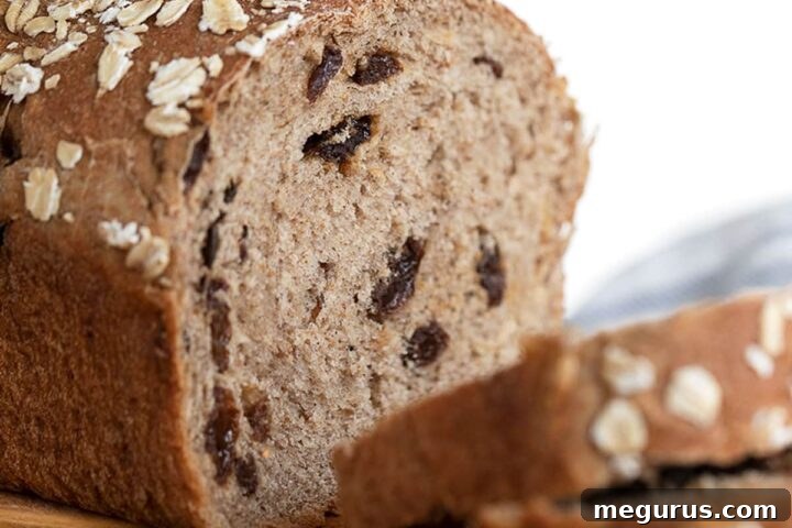 cinnamon raisin oatmeal bread on cutting board sliced