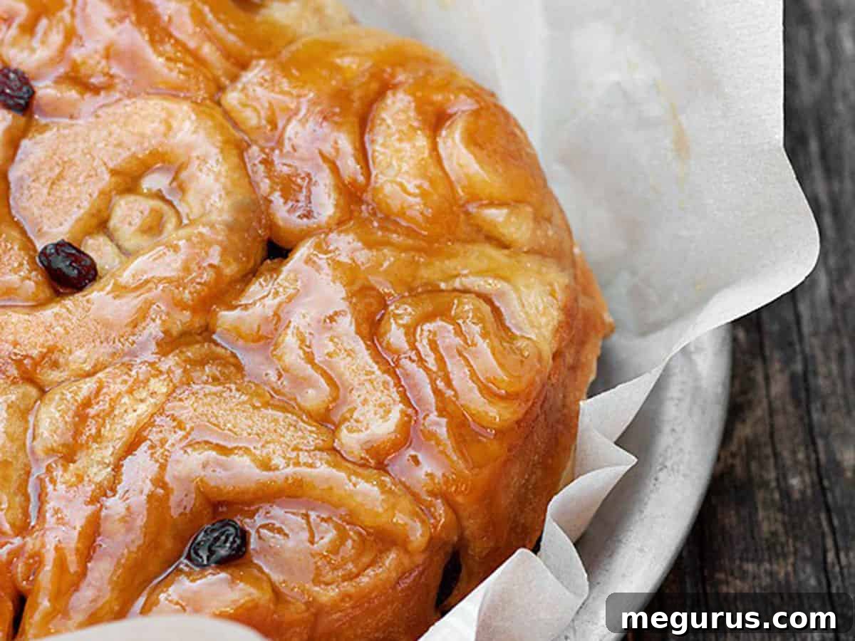 Warm homemade honey buns nestled in a baking tray, golden brown and glazed.
