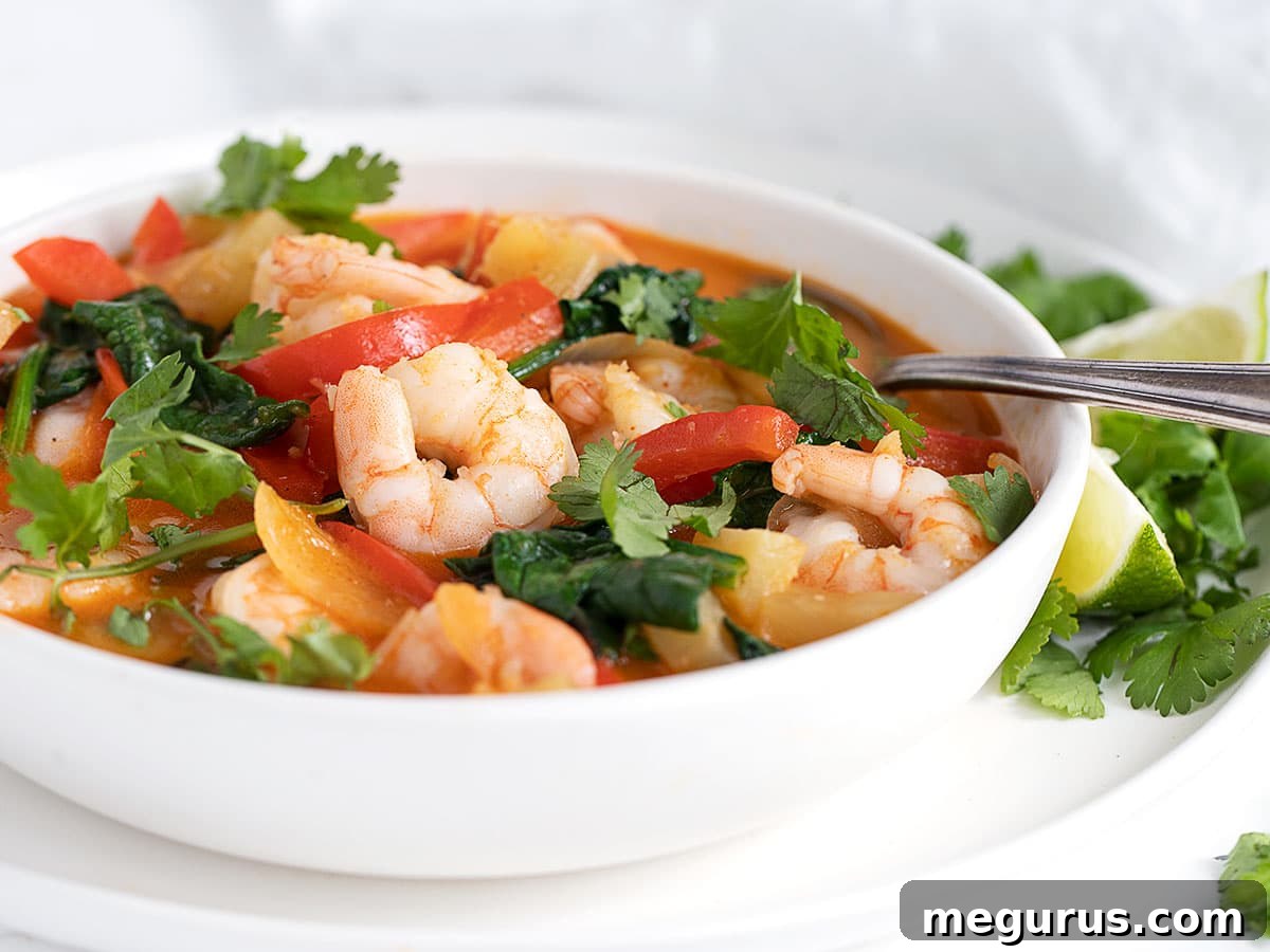 Vibrant Thai Red Curry Shrimp in a white bowl, ready to be served over rice