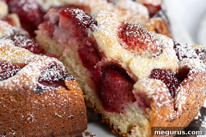Strawberry yogurt cake sliced on a serving plate