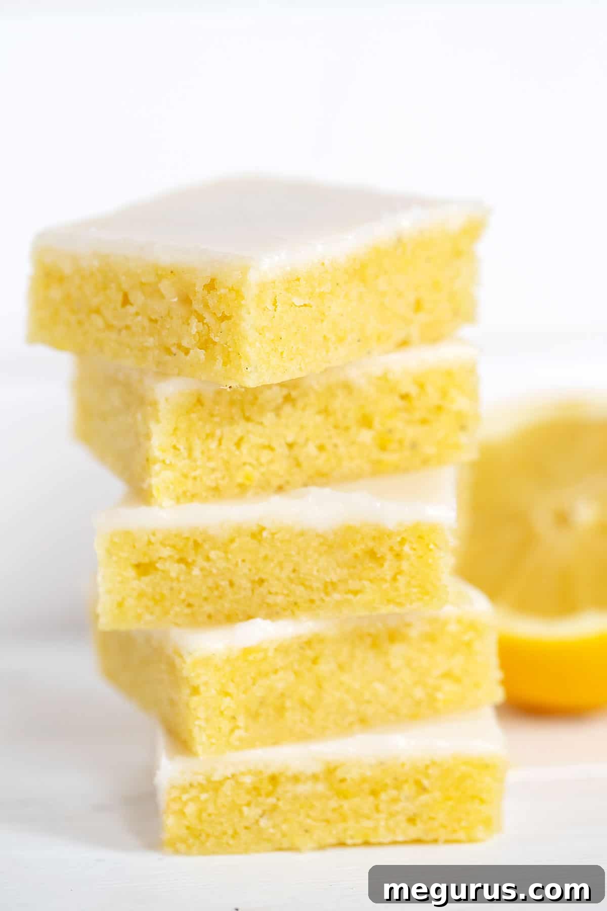 Close-up of perfectly glazed lemon blondies stacked, ready to be served