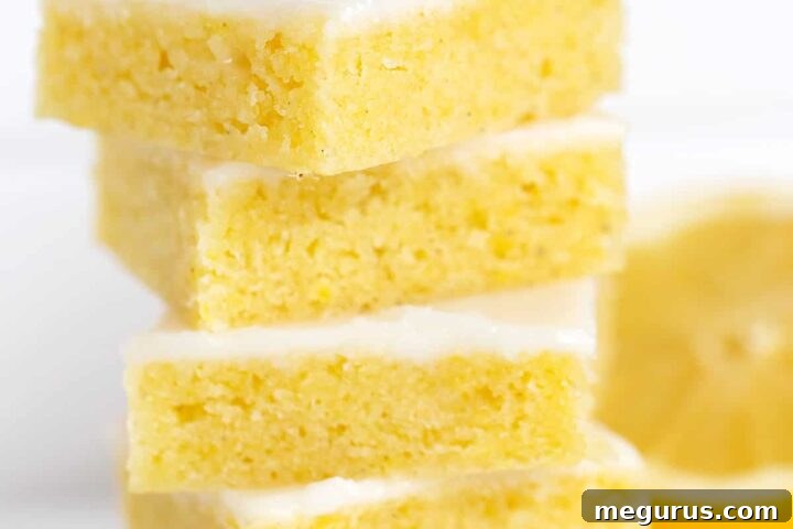 Stacked lemon blondies, showcasing the bright glaze and tender texture