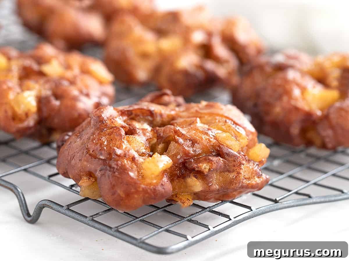 apple fritter yeast doughnuts on cooling rack