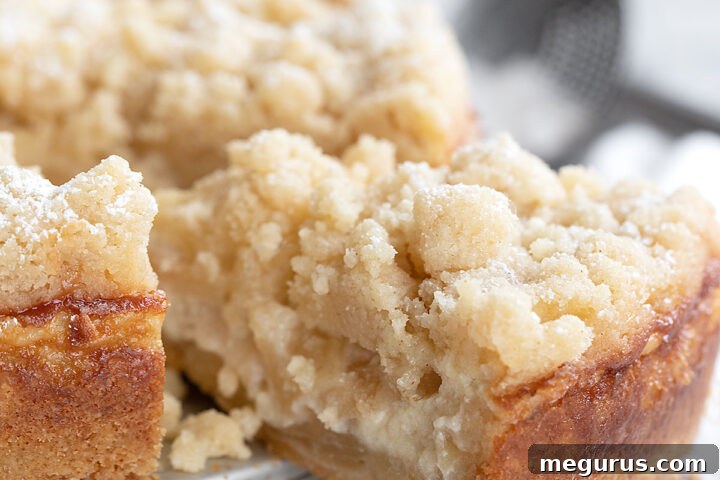Sliced apple crumb cake showing layers