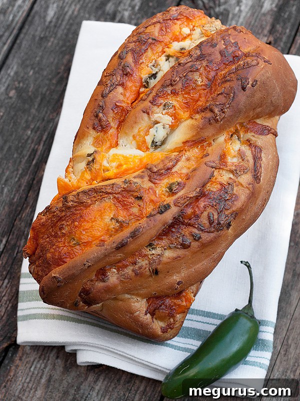 Close-up of a slice of Jalapeño Popper Cheese Bread showing creamy filling