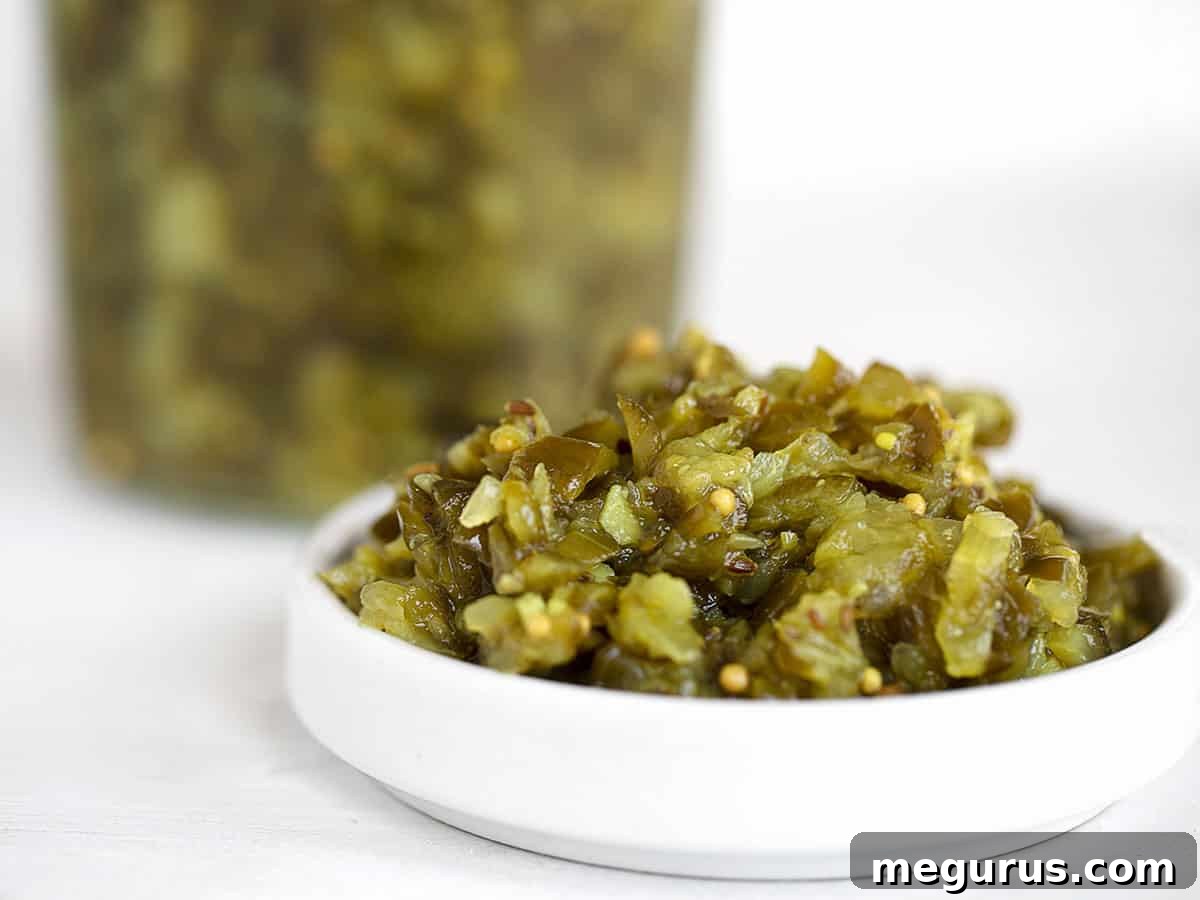 dill pickle relish in white bowl with relish in jar behind