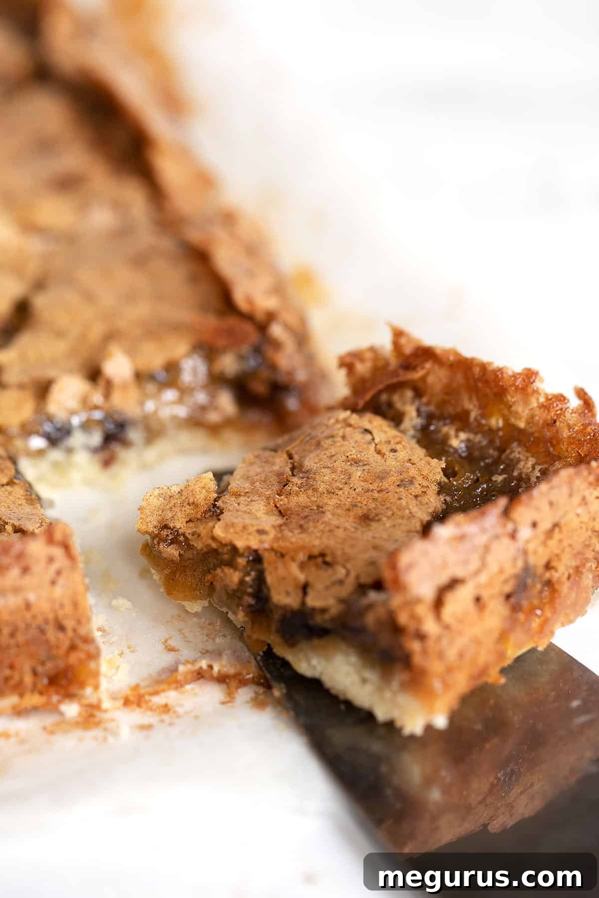 butter tart squares cut on parchment paper