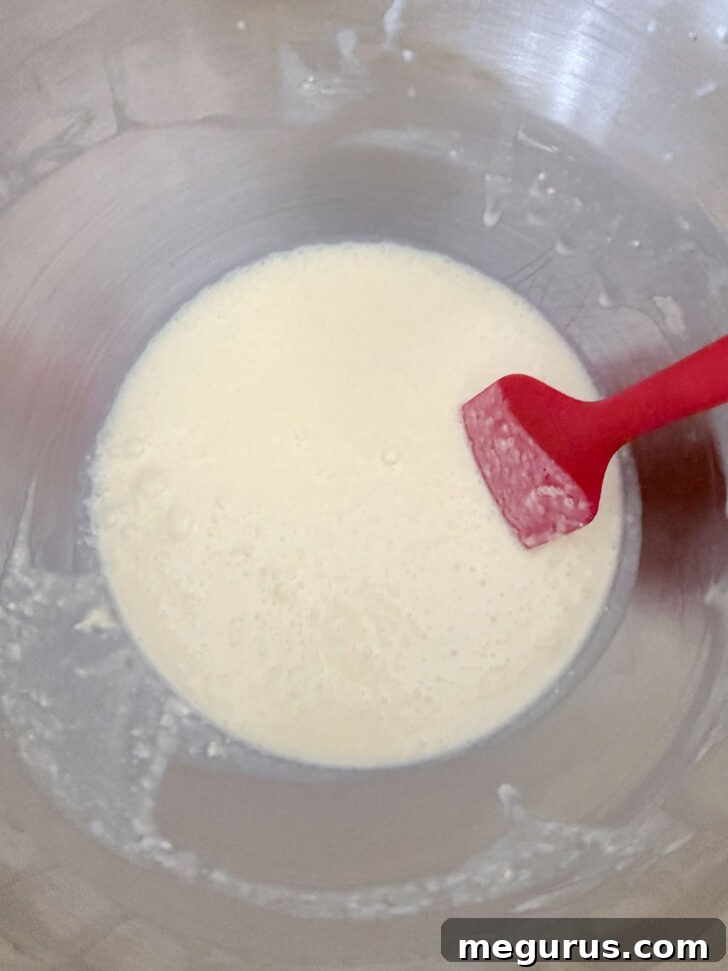 The smooth and thin finished lemon batter resting in the mixing bowl, ready for the next step.