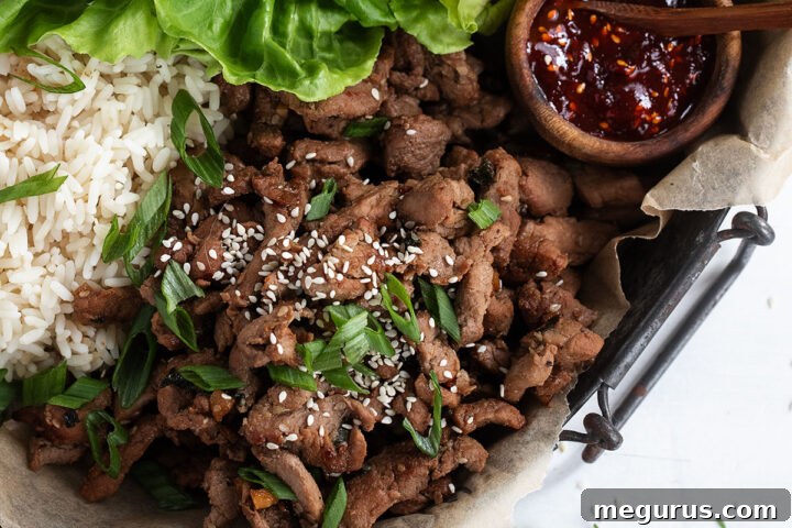 Pork bulgogi attractively arranged on a serving tray with rice and lettuce, prepared for a meal.