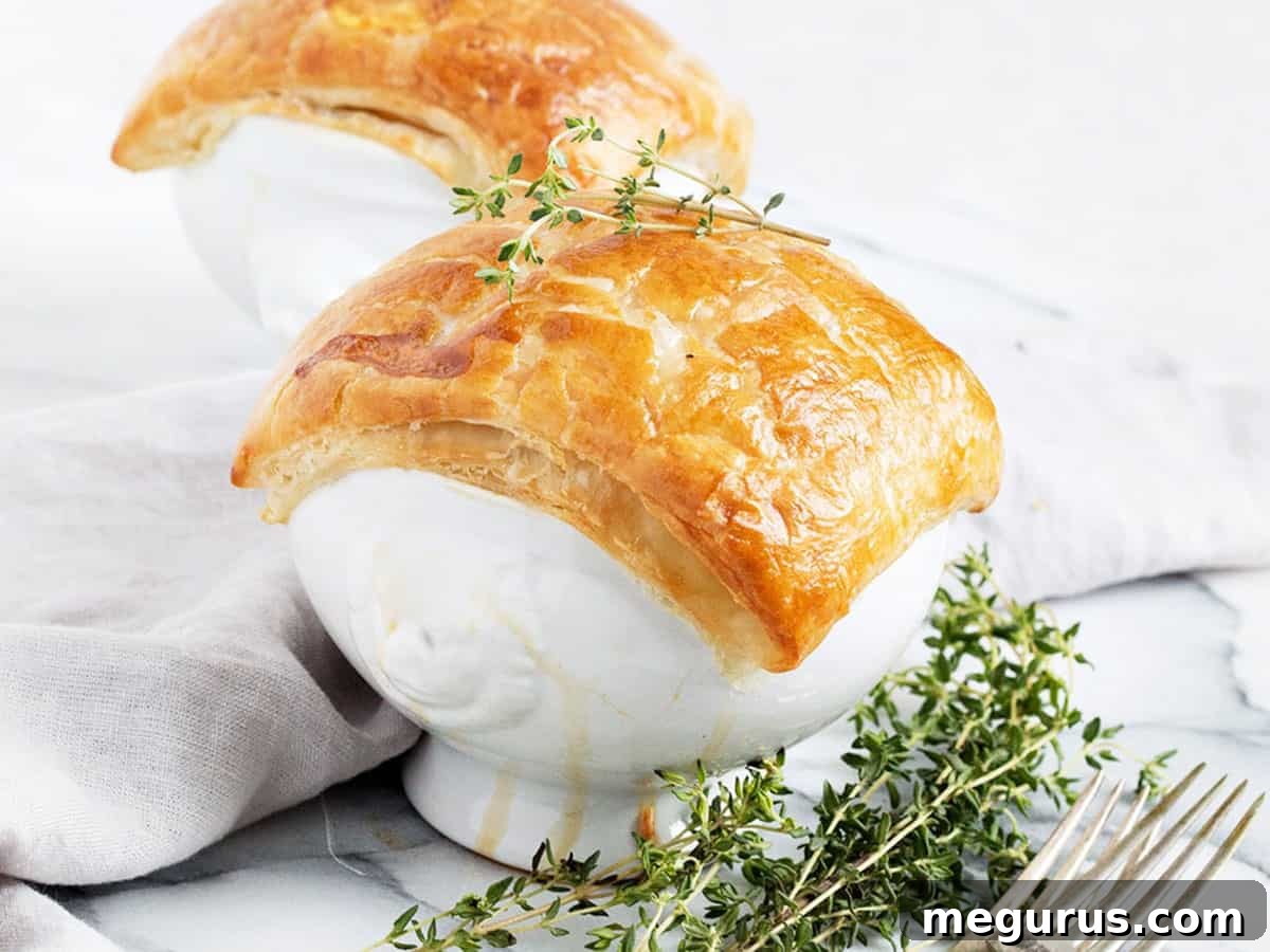 chicken pot pie in white bowls with puff pastry topping