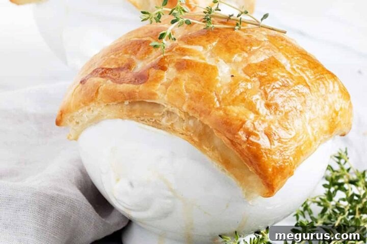 chicken pot pie in white bowls with puff pastry topping