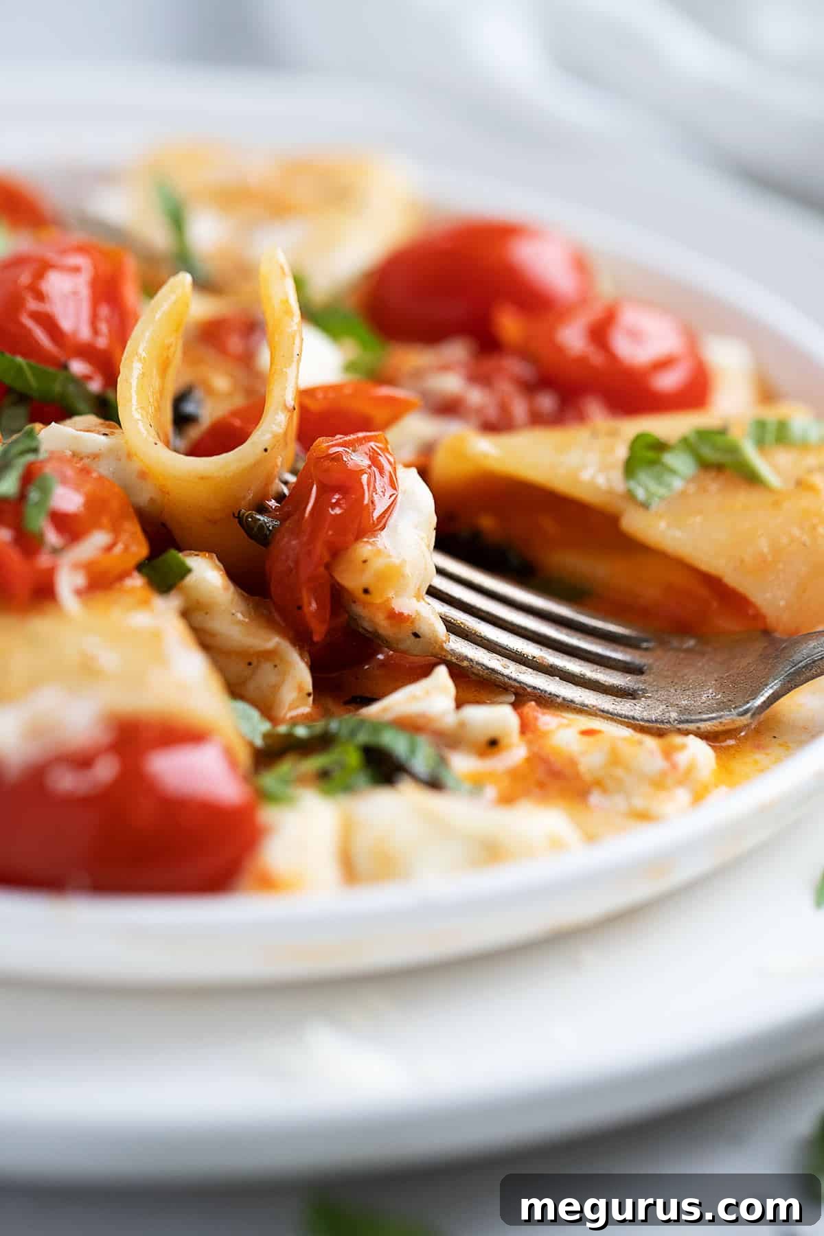 Close-up of freshly served Pasta alla Sorrentina with melted mozzarella and basil