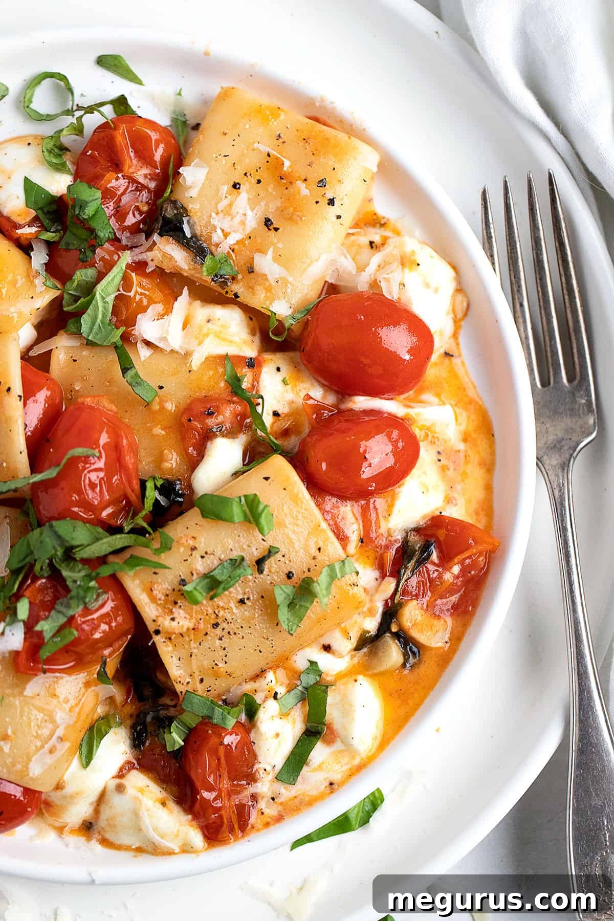 Baked Pasta alla Sorrentina with golden-brown cheese and fresh basil garnish