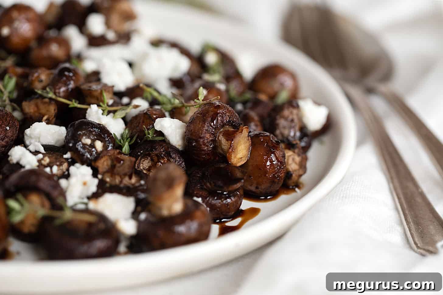 Air-fried mushrooms finished with balsamic glaze and goat cheese, served in a rustic bowl.