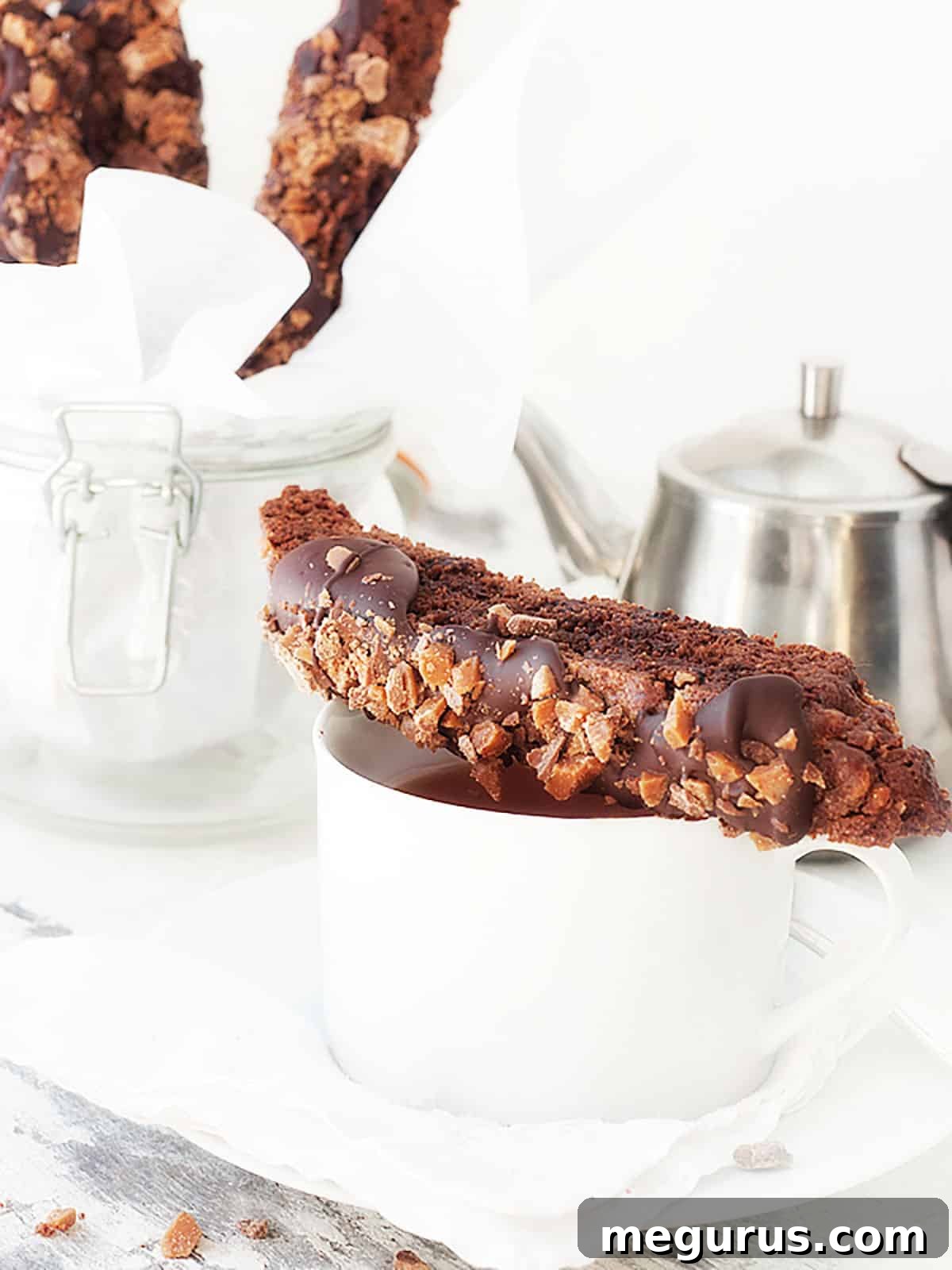 double chocolate toffee biscotto on top of coffee cup