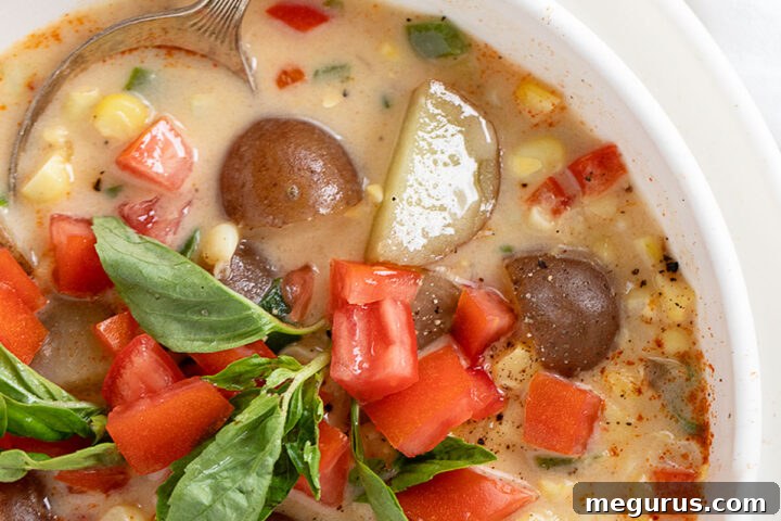 Delicious and vibrant Light Corn Chowder in a white bowl, ready to be served.