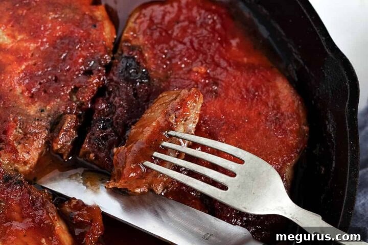 baked bbq pork chops in cast iron skillet, ready to serve