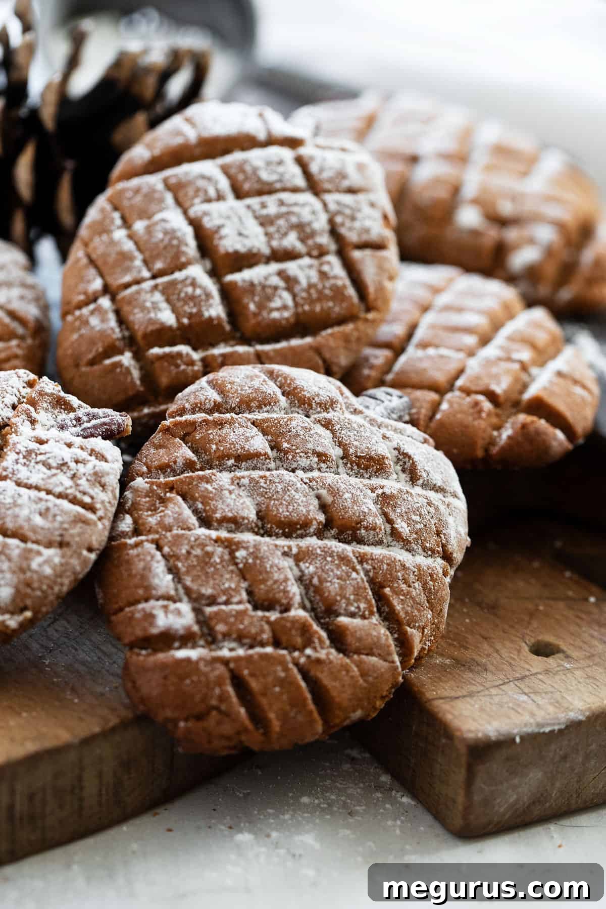 A close-up shot of freshly baked gingerbread pinecone cookies, beautifully shaped and textured, ready to be enjoyed as a festive holiday treat.