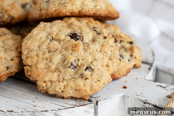 Classic old-fashioned oatmeal raisin cookies on a serving board, highlighting their perfectly baked texture and inviting appearance.