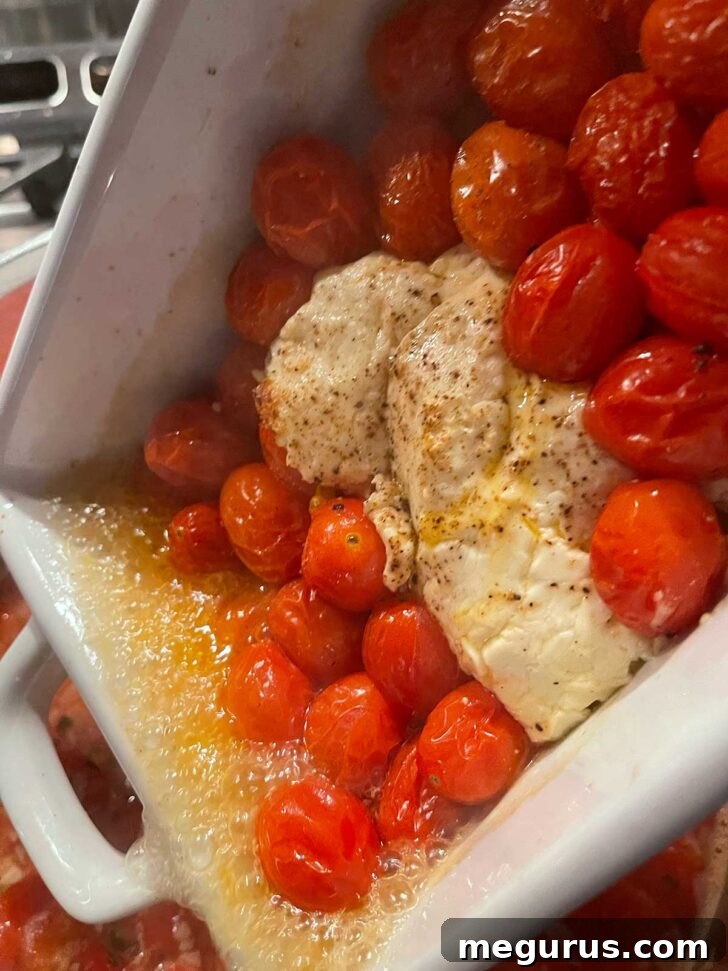 Adding roasted cherry tomatoes and feta to the simmering soup pot.