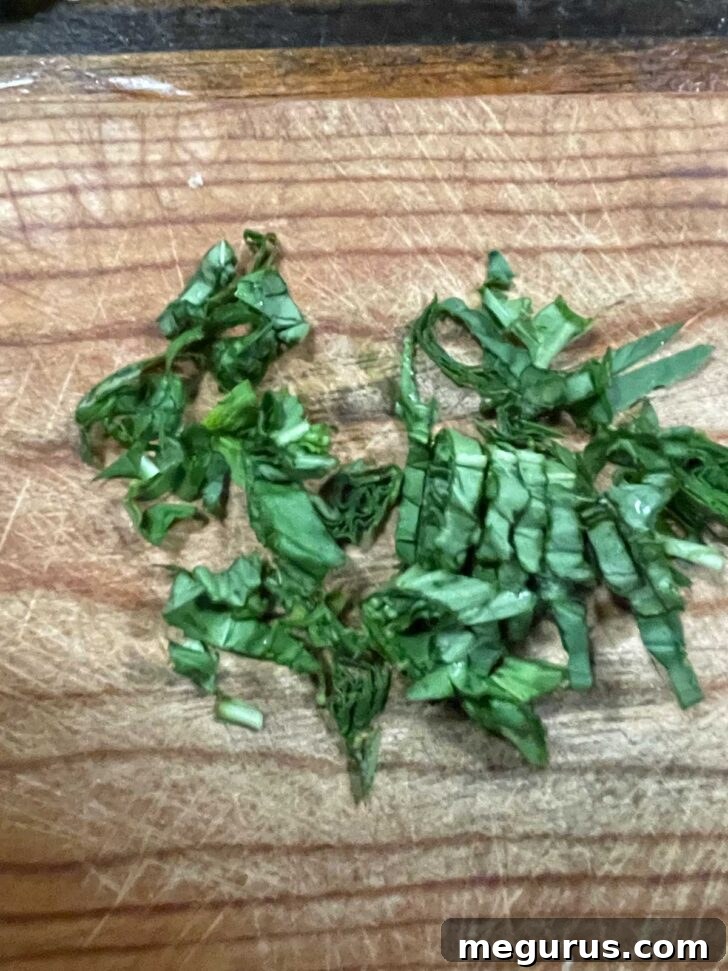 Freshly chopped basil, ready to be added to the soup.