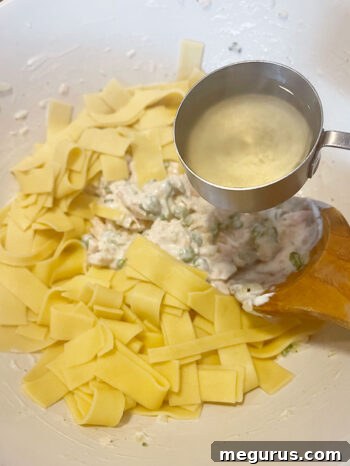 Tuna filling with cooked egg noodles and added pasta water
