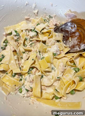 Tuna casserole ingredients all stirred together in a bowl