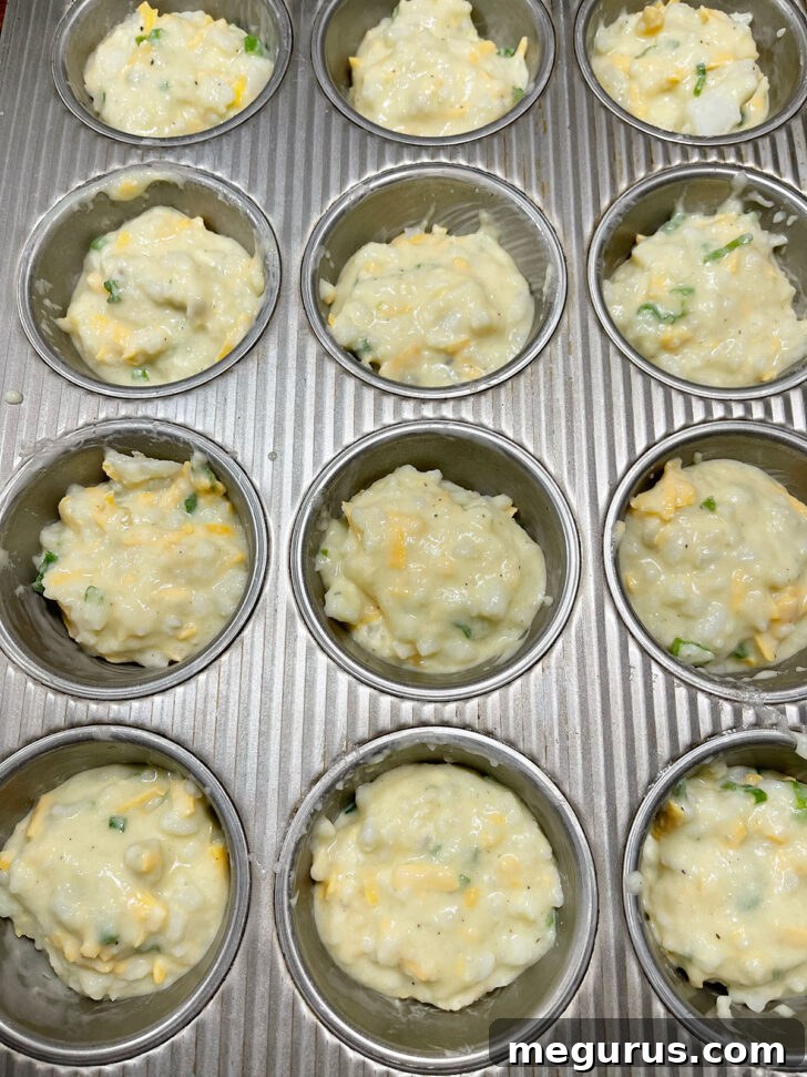 Mashed potato batter perfectly scooped into muffin cups, ready for baking.