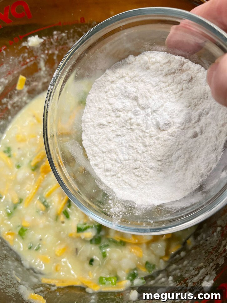 Adding all-purpose flour and baking powder to the mashed potato mixture.