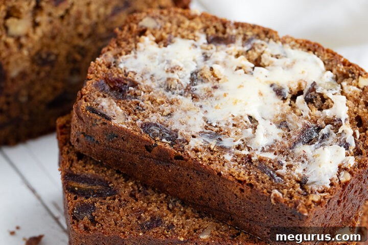 A beautiful loaf of date nut bread, perfectly sliced and presented.