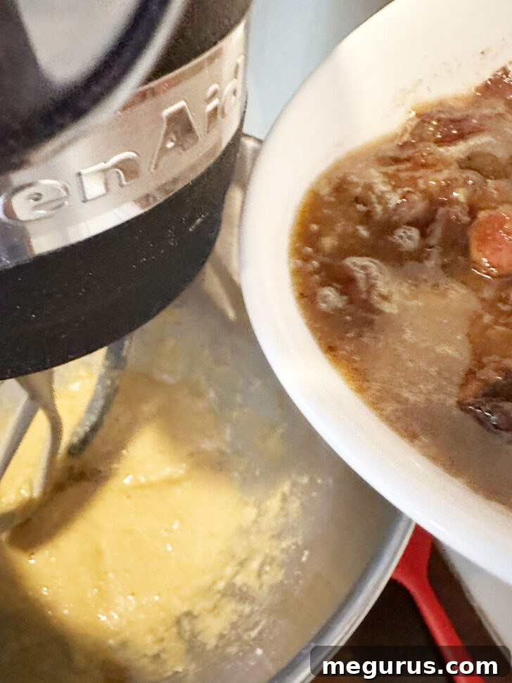 The cooled, soaked date mixture being added to the wet batter ingredients.