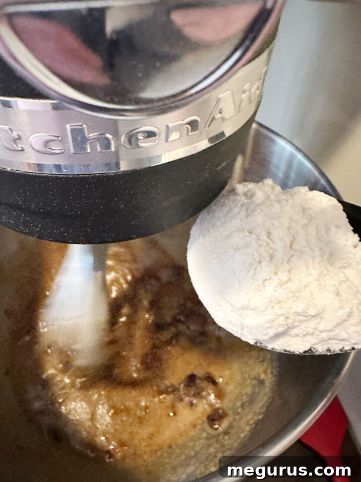 The dry flour mixture being added to the wet date nut bread batter.