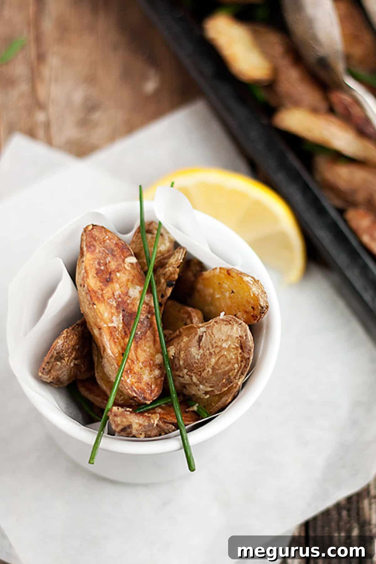 parmesan fingerling potatoes in bowl and on baking sheet