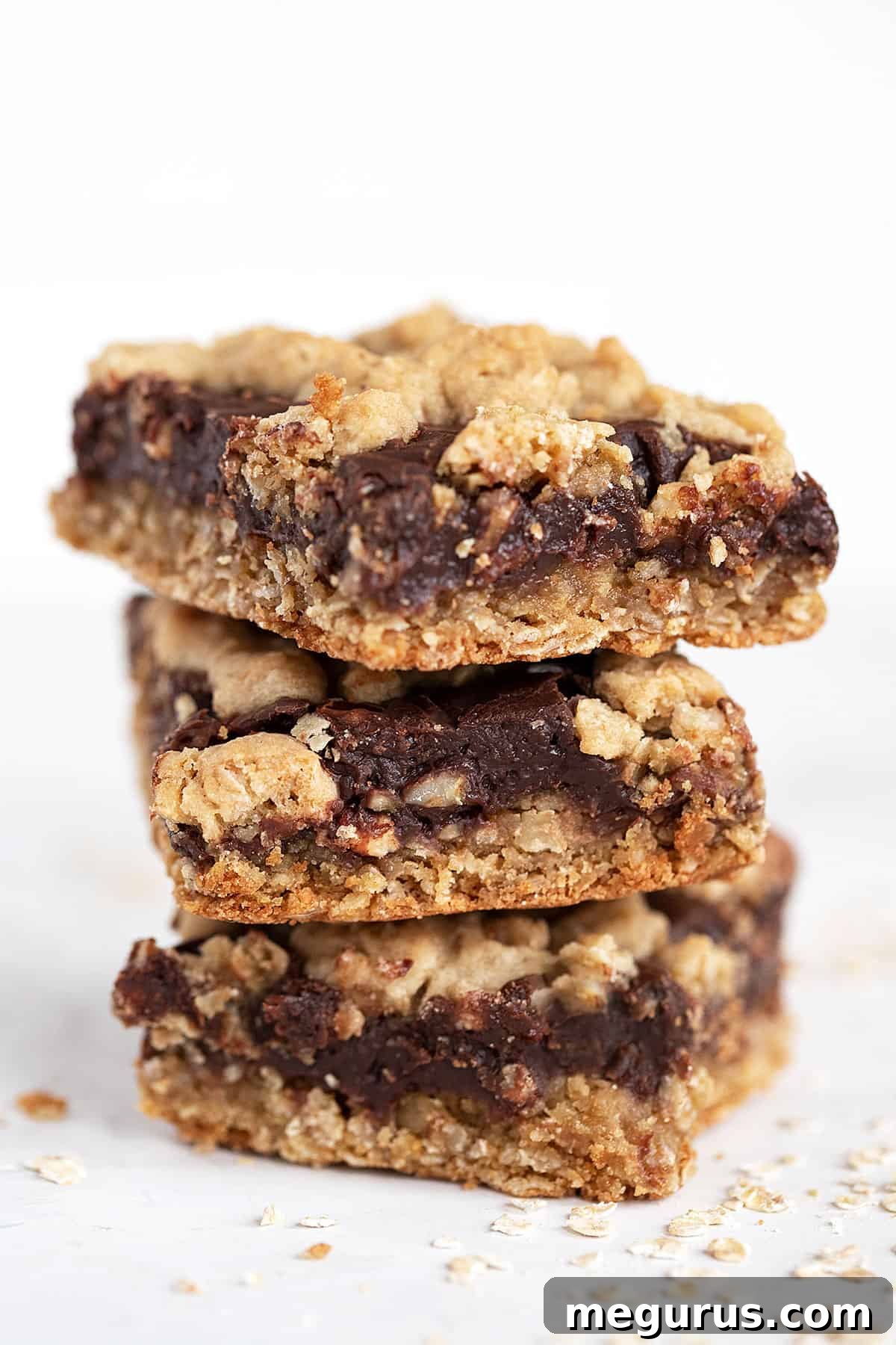 A stack of perfectly cut chocolate oatmeal bars, showcasing the distinct layers.