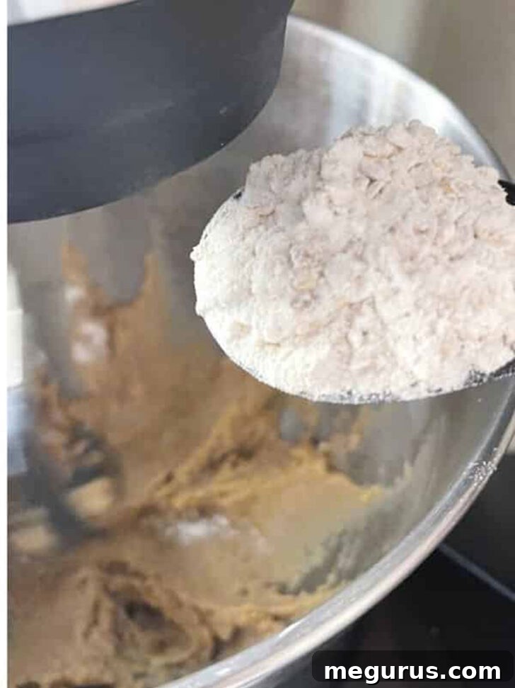 Gradually adding the dry flour mixture to the wet ingredients.