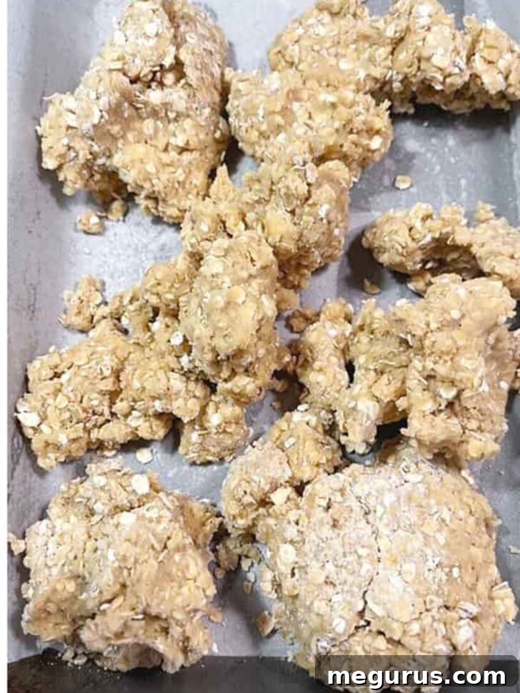 Approximately two-thirds of the dough pressed into a parchment-lined baking pan.