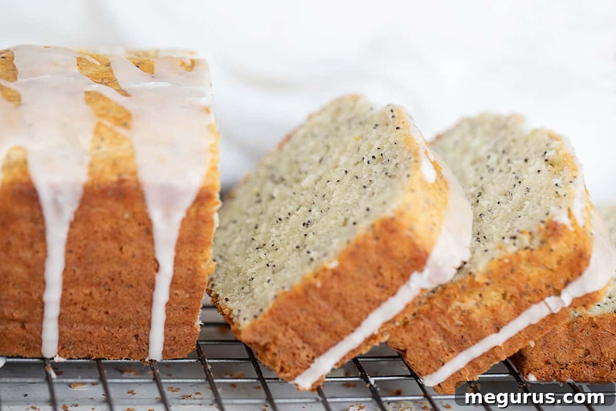 Freshly baked lemon poppy seed loaf, elegantly sliced and resting on a wire cooling rack