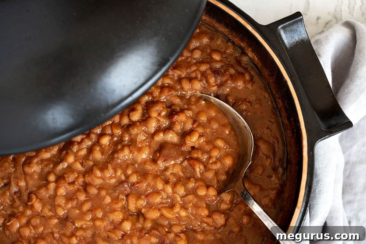 maple baked beans in casserole dish with spoon
