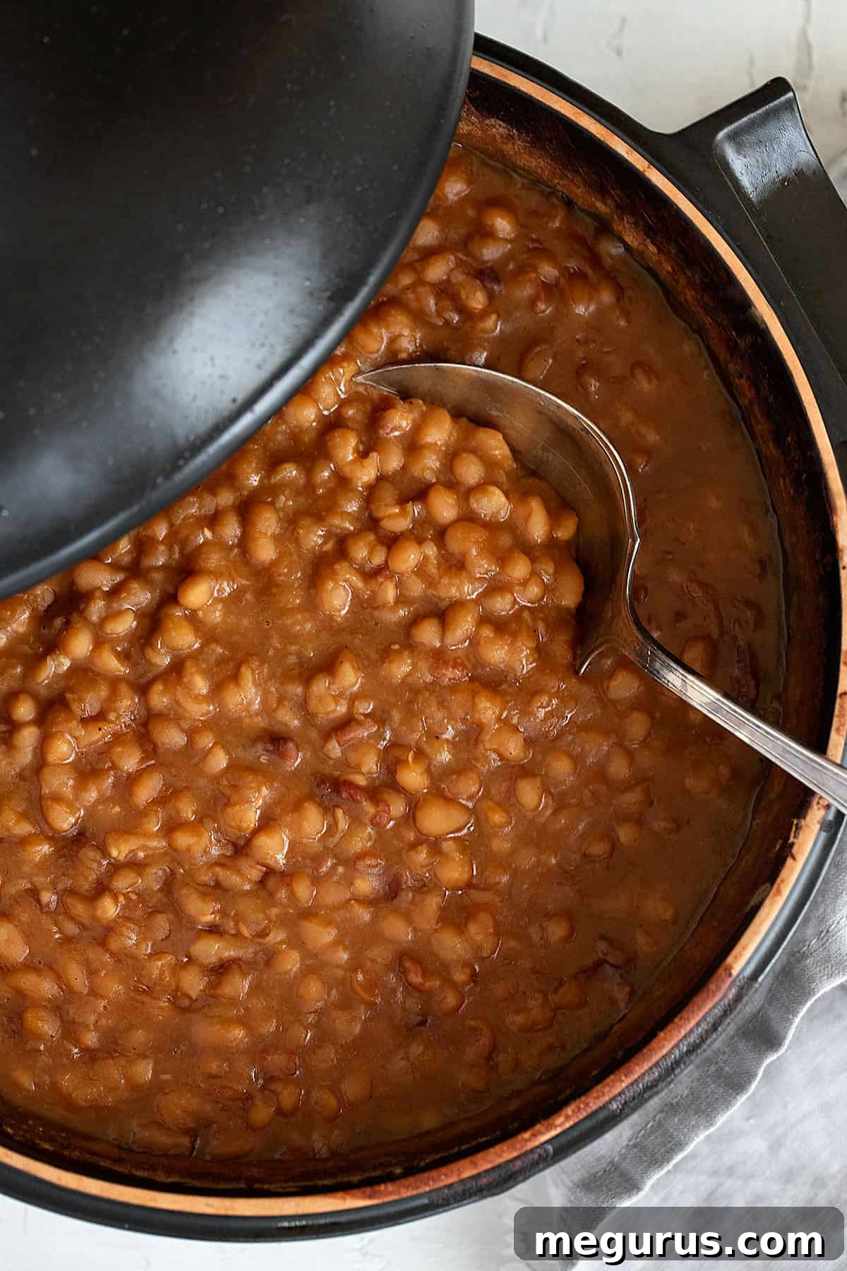 maple baked beans in pot with spoon