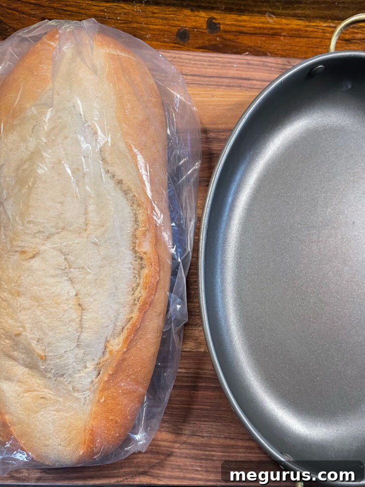 Loaf of bread and baking pan set out.