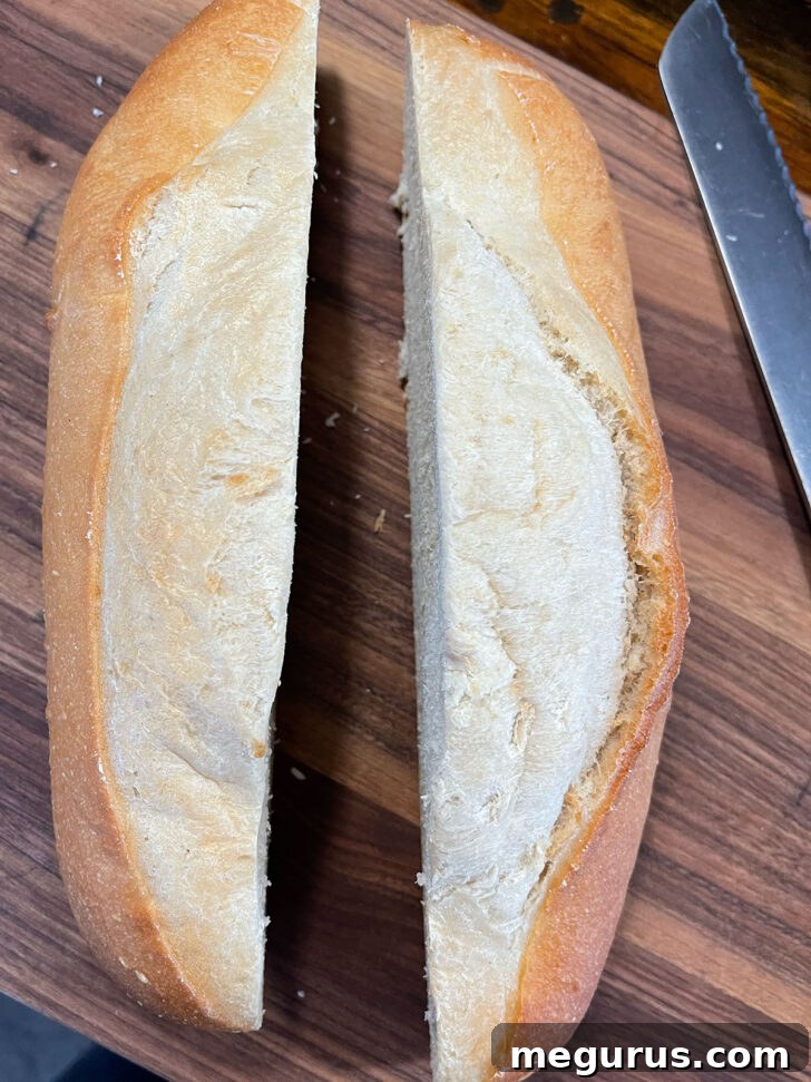Cutting bread in half lengthwise. 