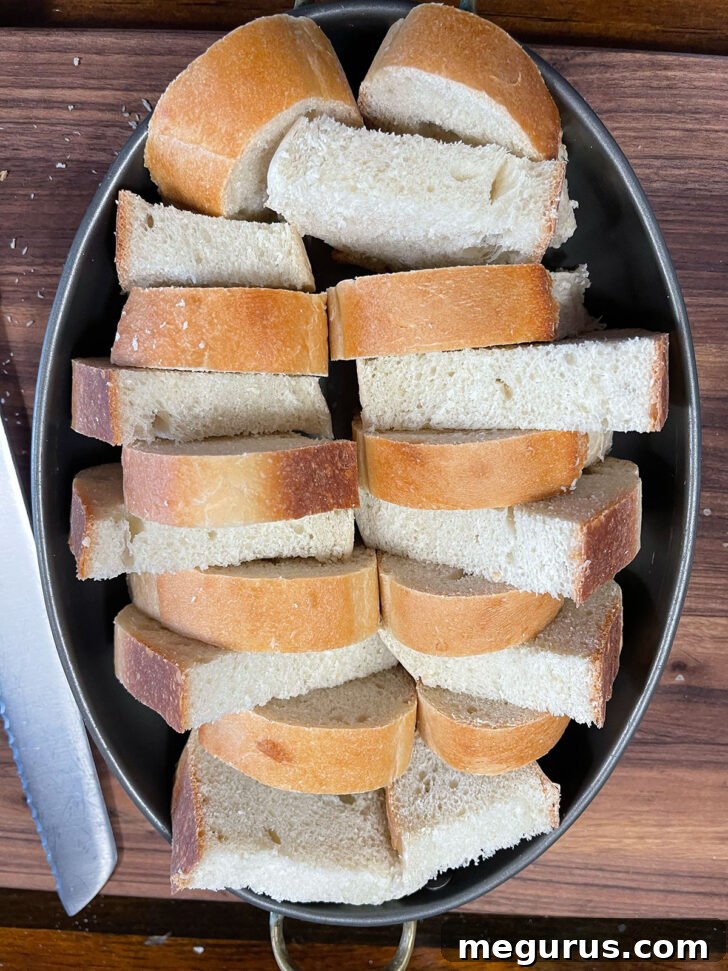Bread slices arranged in baking dish.