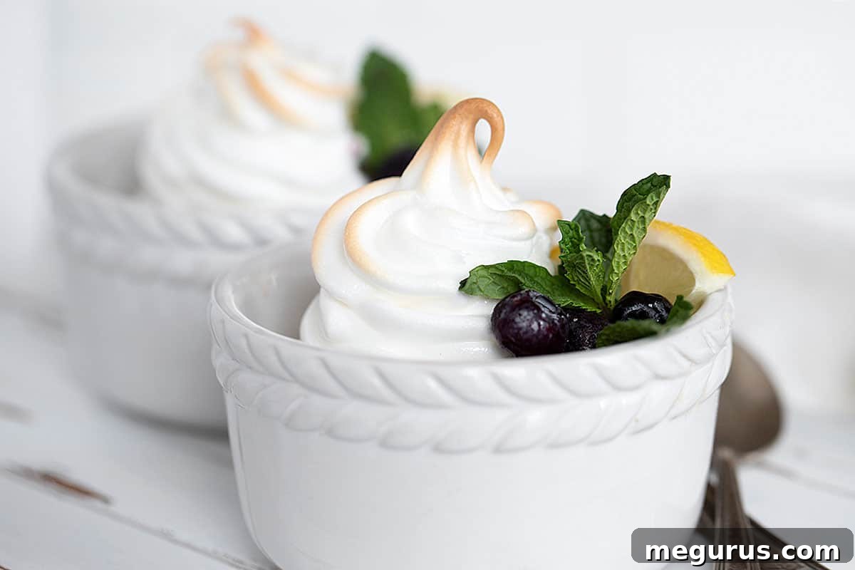 Delightful lemon meringue pudding served in elegant white ramekins, garnished with fresh blueberries.