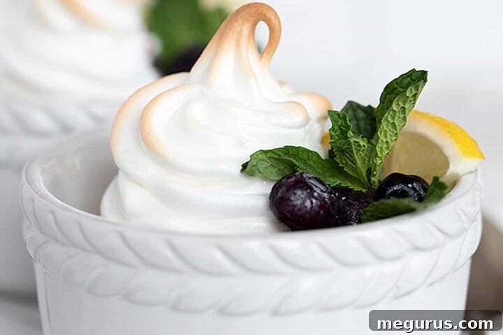 lemon meringue pudding in white ramekins with blueberries